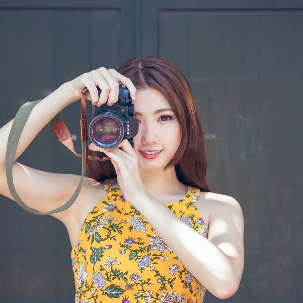 Девушка азиатка с фотоаппаратов в руках