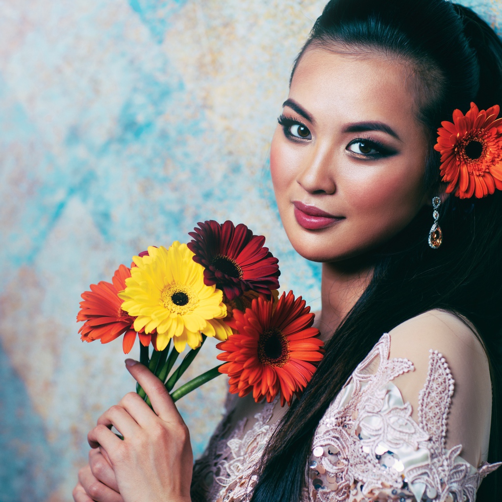 Красивая девушка азиатка с букетом гербер в руках