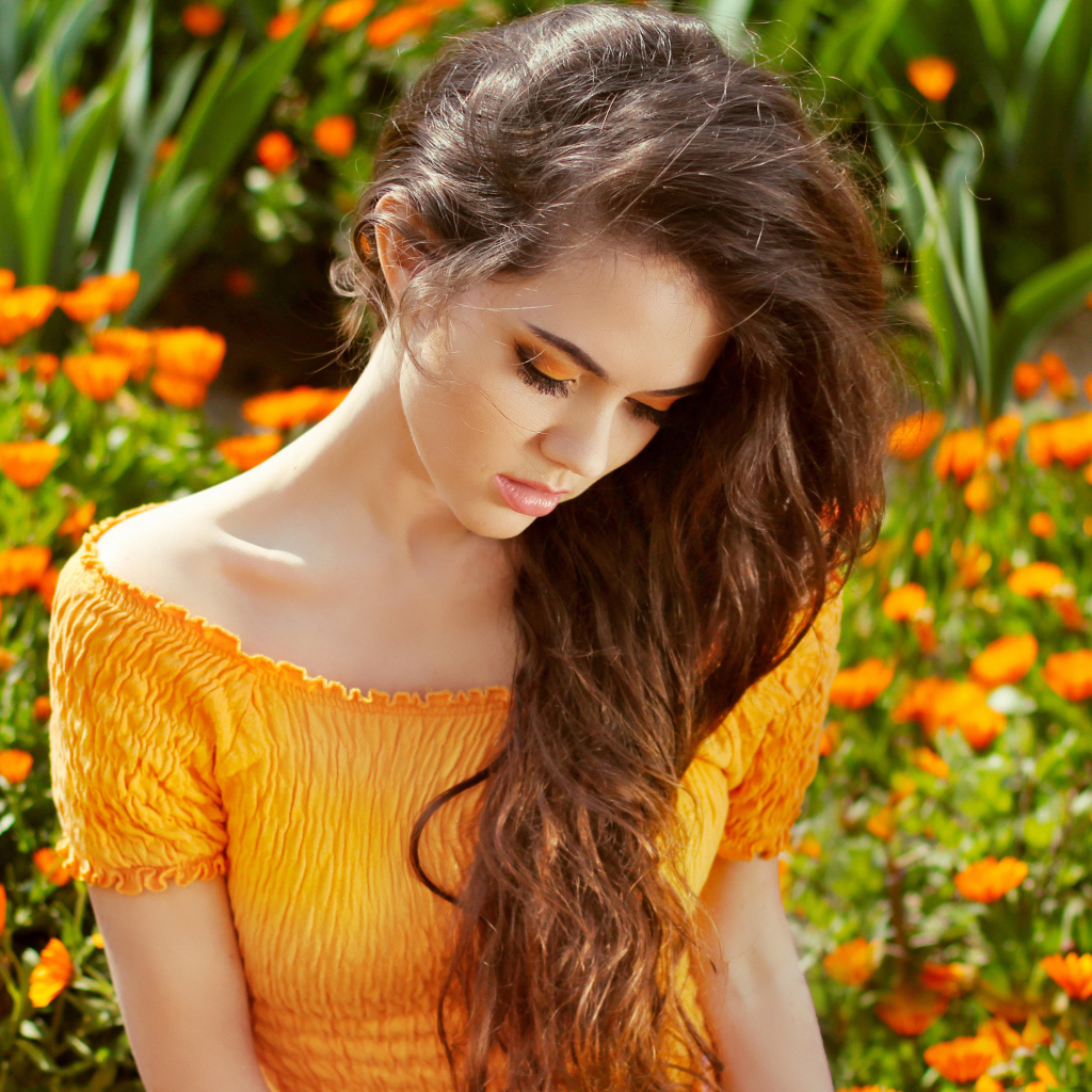 Красивая девушка у цветов календулы