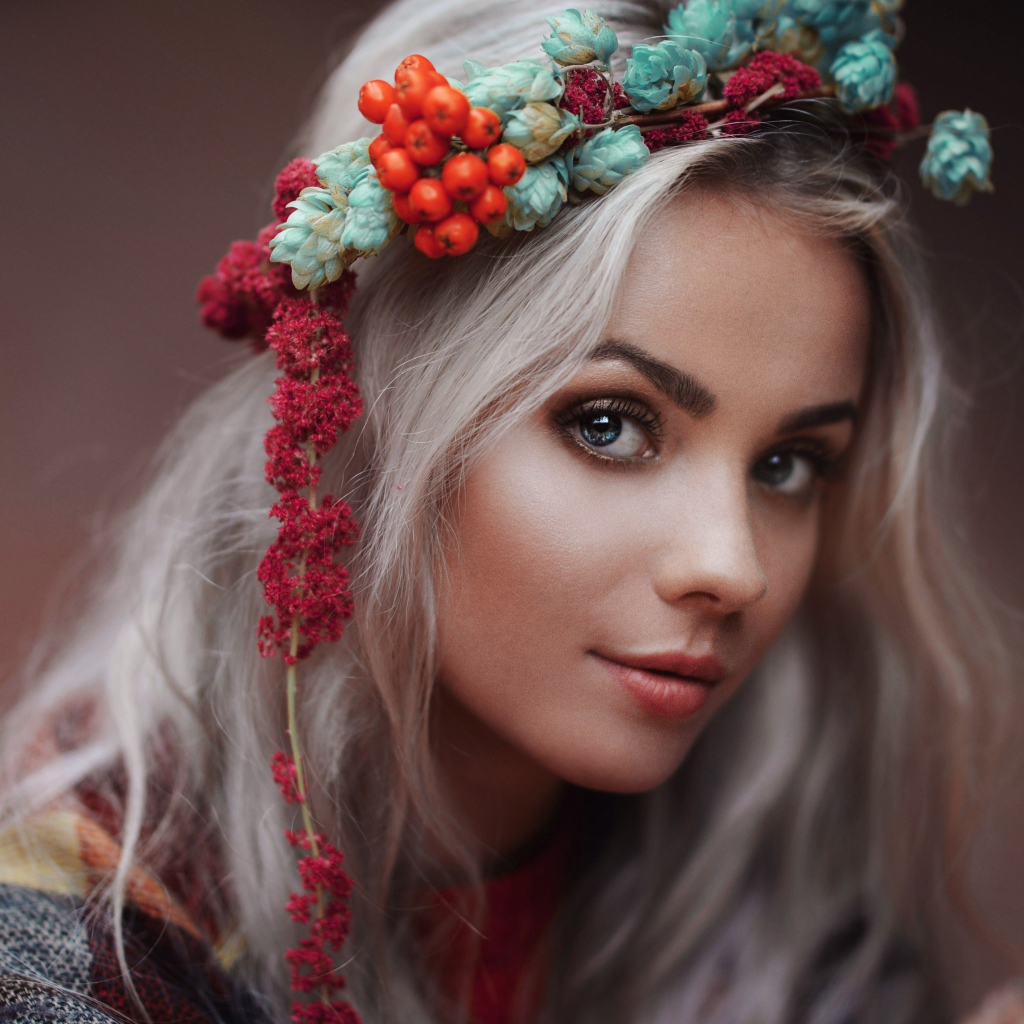 Молодая голубоглазая девушка с венком на голове