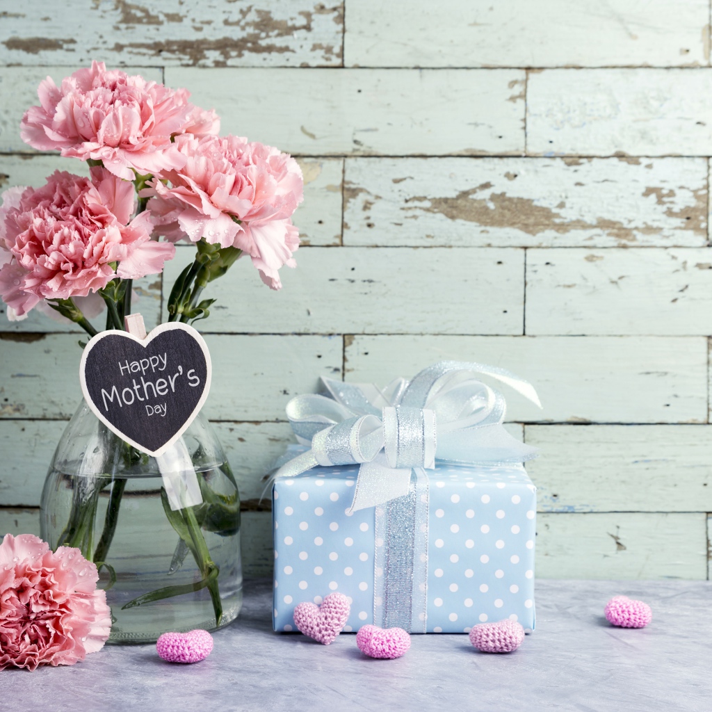 A bouquet of pink carnations and a gift for mother's day