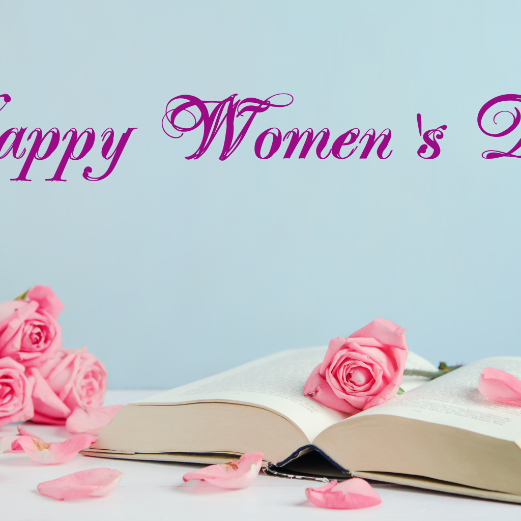 Open book and pink roses for International Women's Day