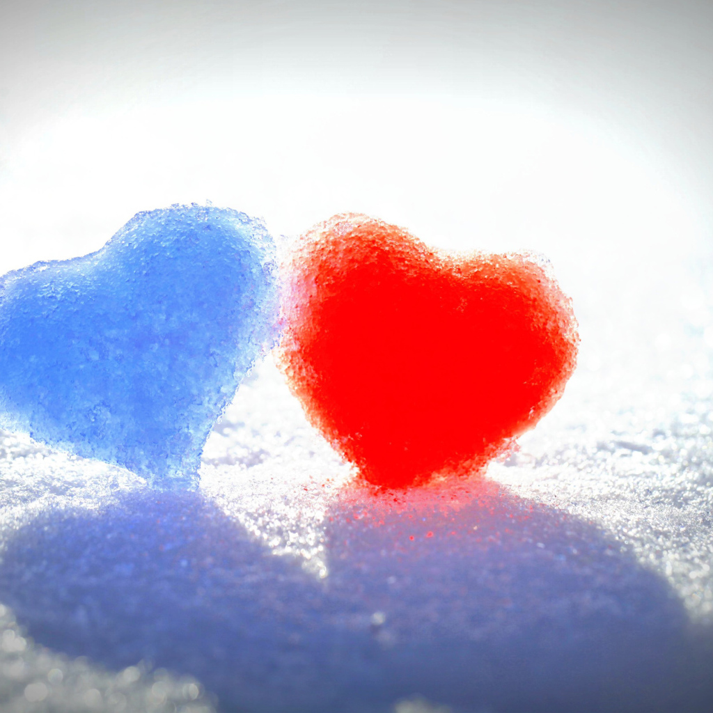 Голубое и красное сердце на белом снегу 