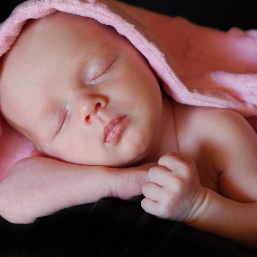 Милый спящий младенец под розовым покрывалом