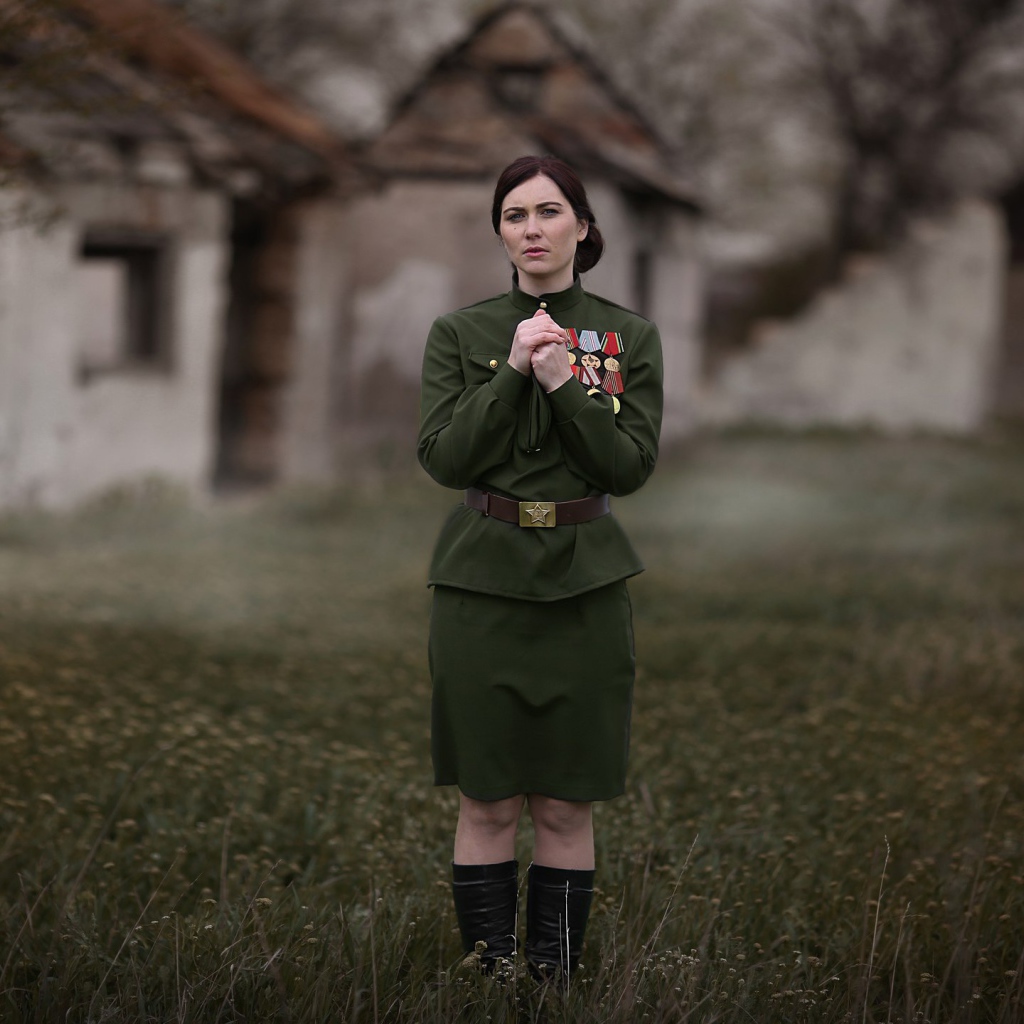 A girl in a tunic with military awards for May 9, retro