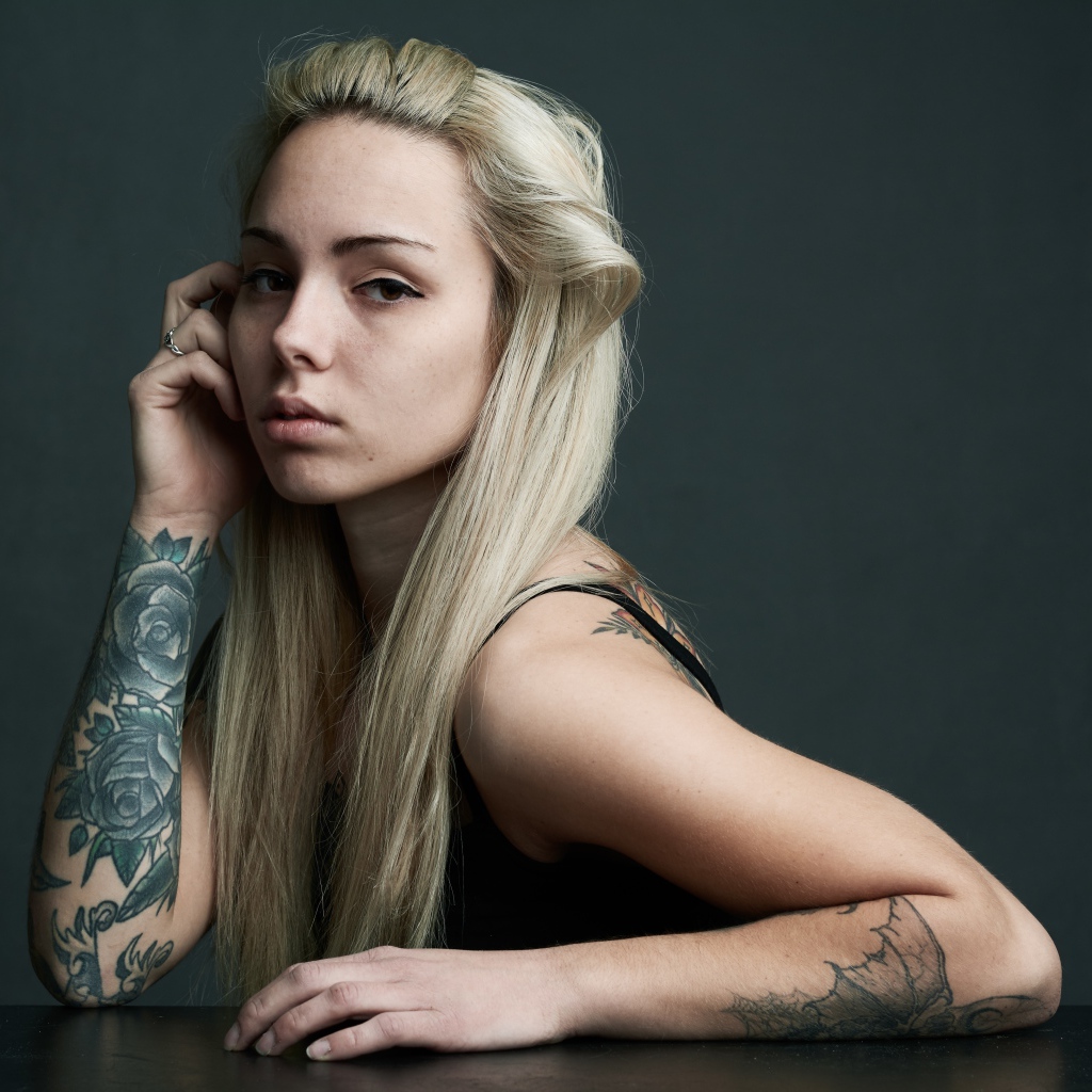 Young girl with white hair with tattoos on her body