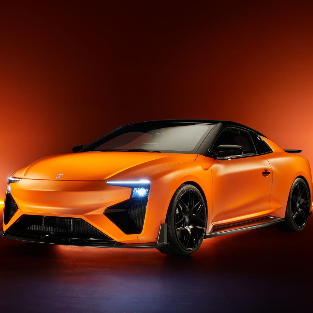Оранжевый автомобиль Gumpert RG Nathalie 2019 года с включенными фарами