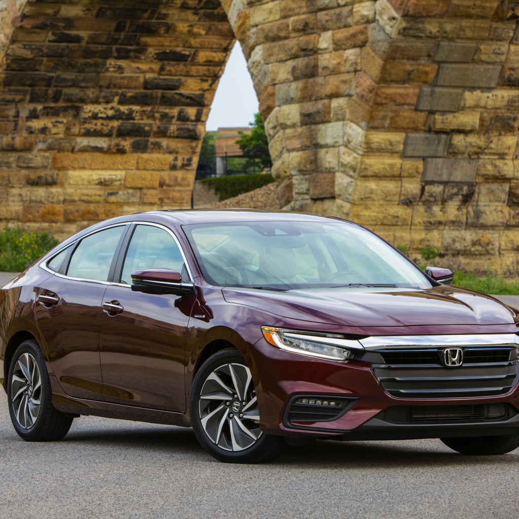 Бордовый автомобиль Honda Insight у моста