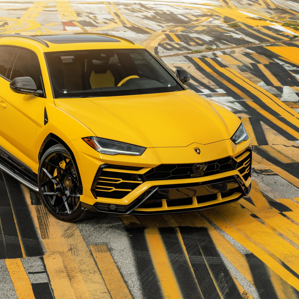 Yellow SUV Lamborghini Urus on multi-colored asphalt
