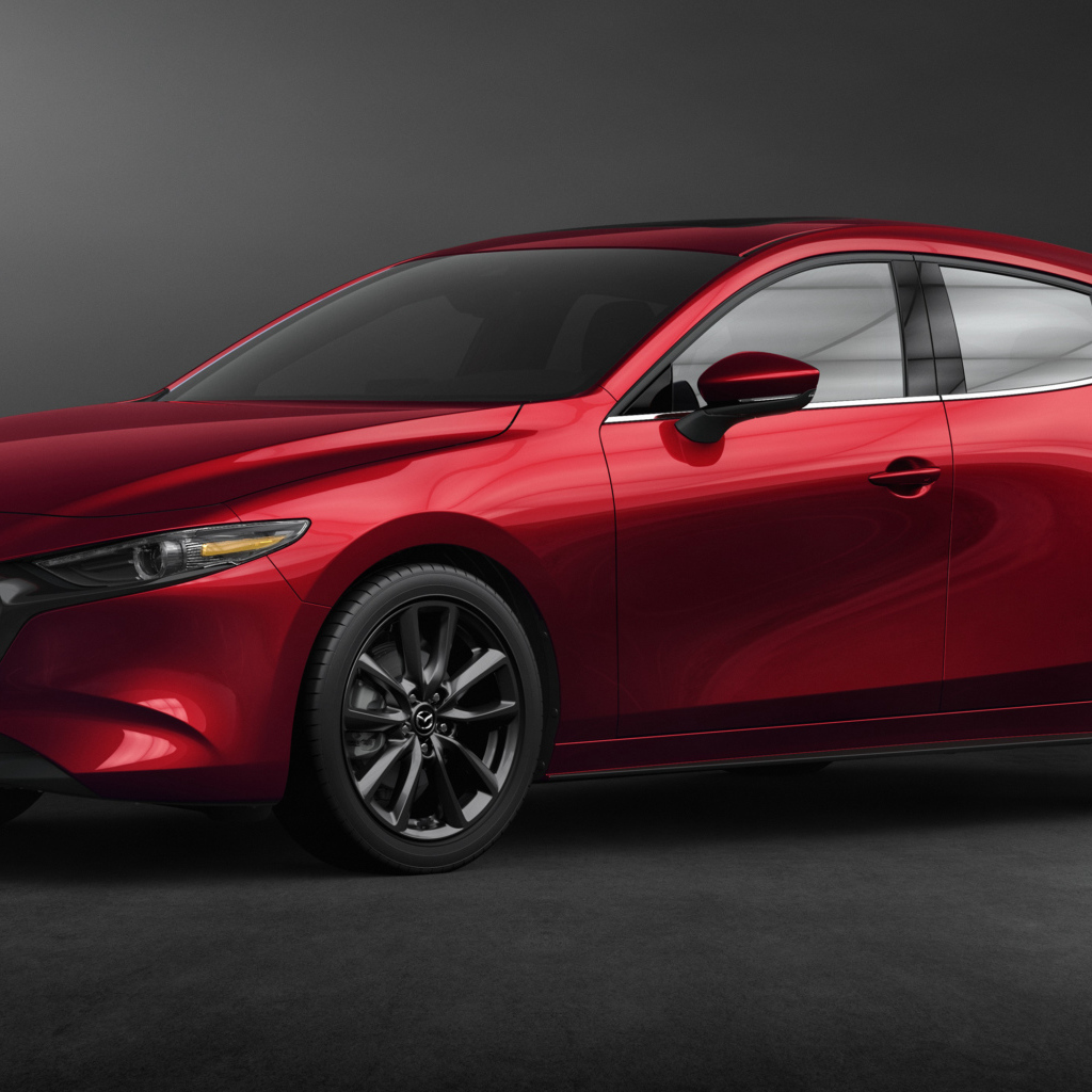 Красный автомобиль Mazda 3, 2020 года на сером фоне