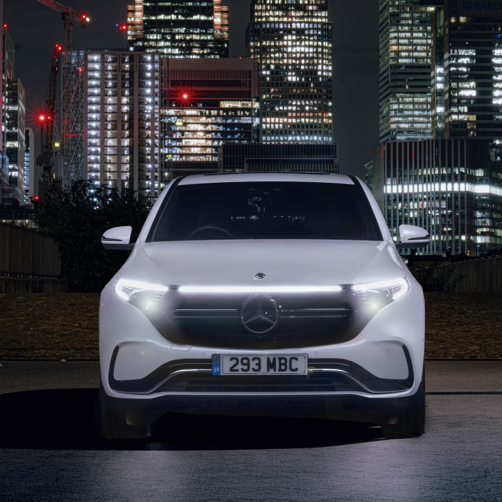Car Mercedes-Benz EQC 400 4MATIC AMG Line 2019 against the backdrop of skyscrapers
