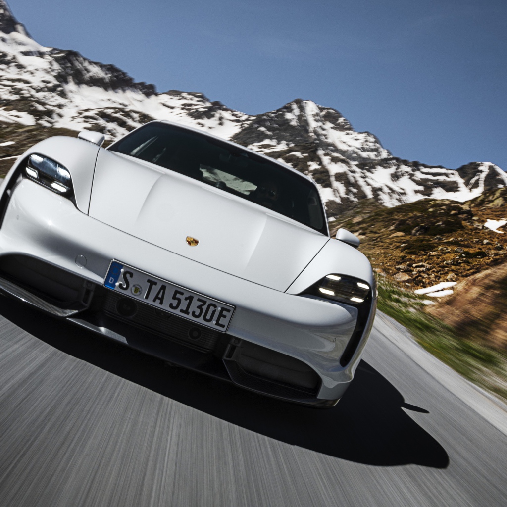 White 2019 Porsche Taycan Turbo S car on a background of snow-capped mountains