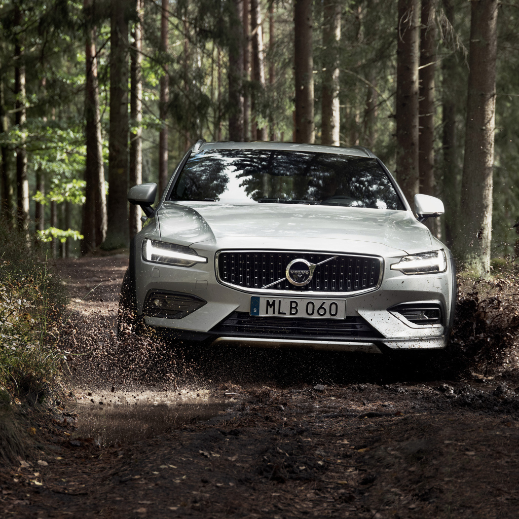 Silver car Volvo V60 T5 goes on a muddy forest road