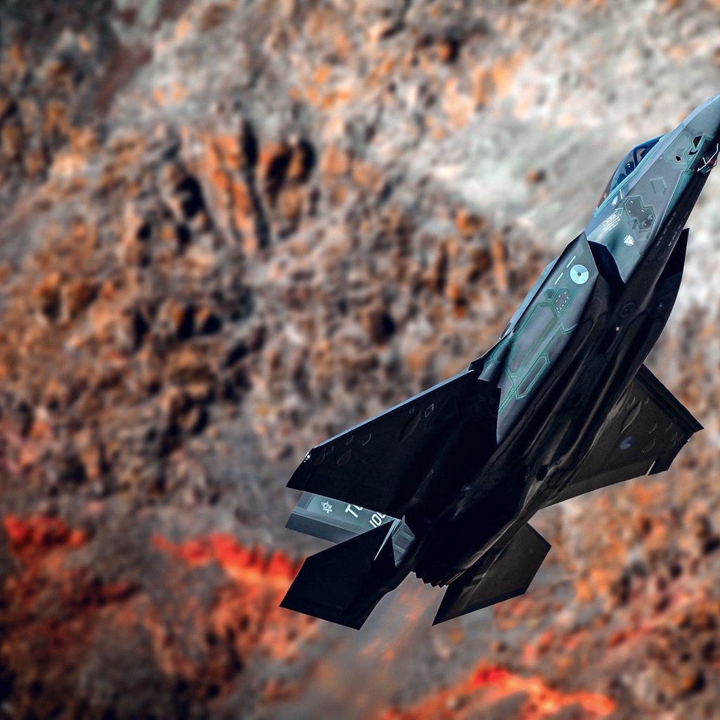Black fighter F-35A Lightning II on the background of mountains