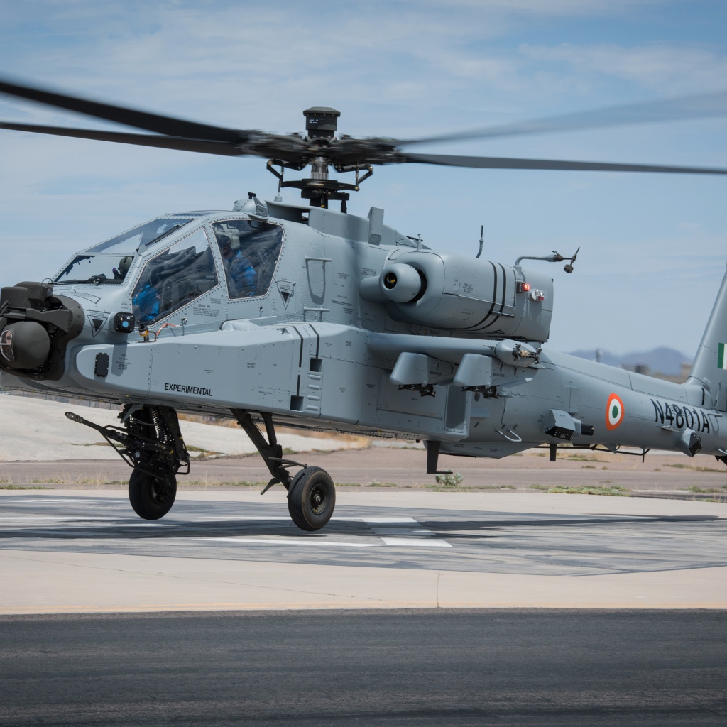 Military helicopter Boeing AH-64 Apache is preparing for takeoff