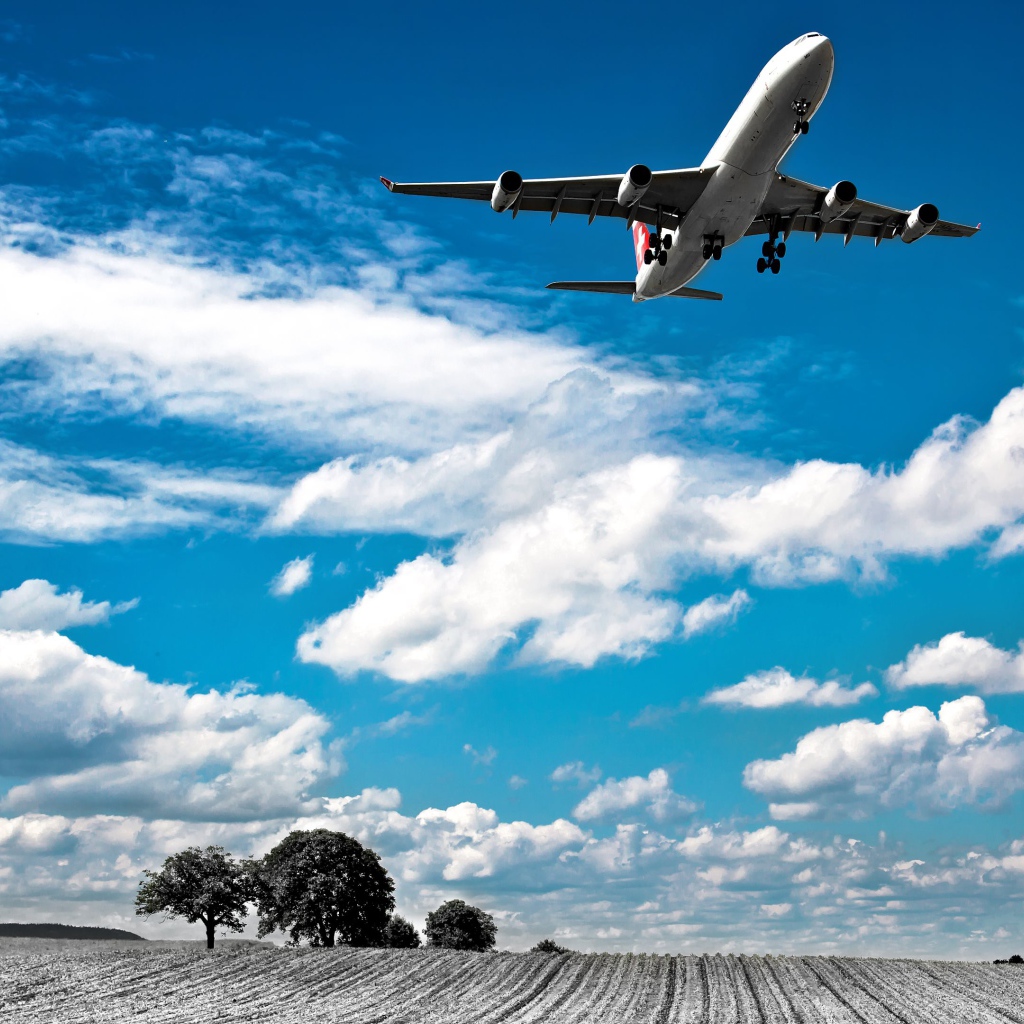 Самолет авиакомпании Swiss Airlines в небе с белыми облаками