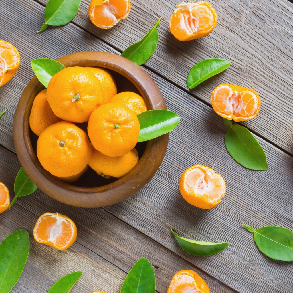 Спелые оранжевые мандарины на деревянном столе вид сверху