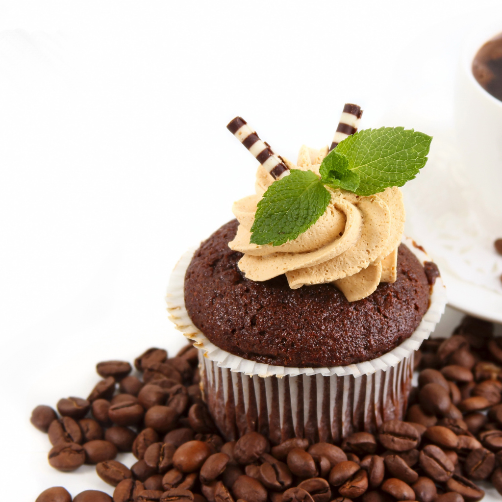 Шоколадный кекс с кремом на столе кофе и кофейными зернами