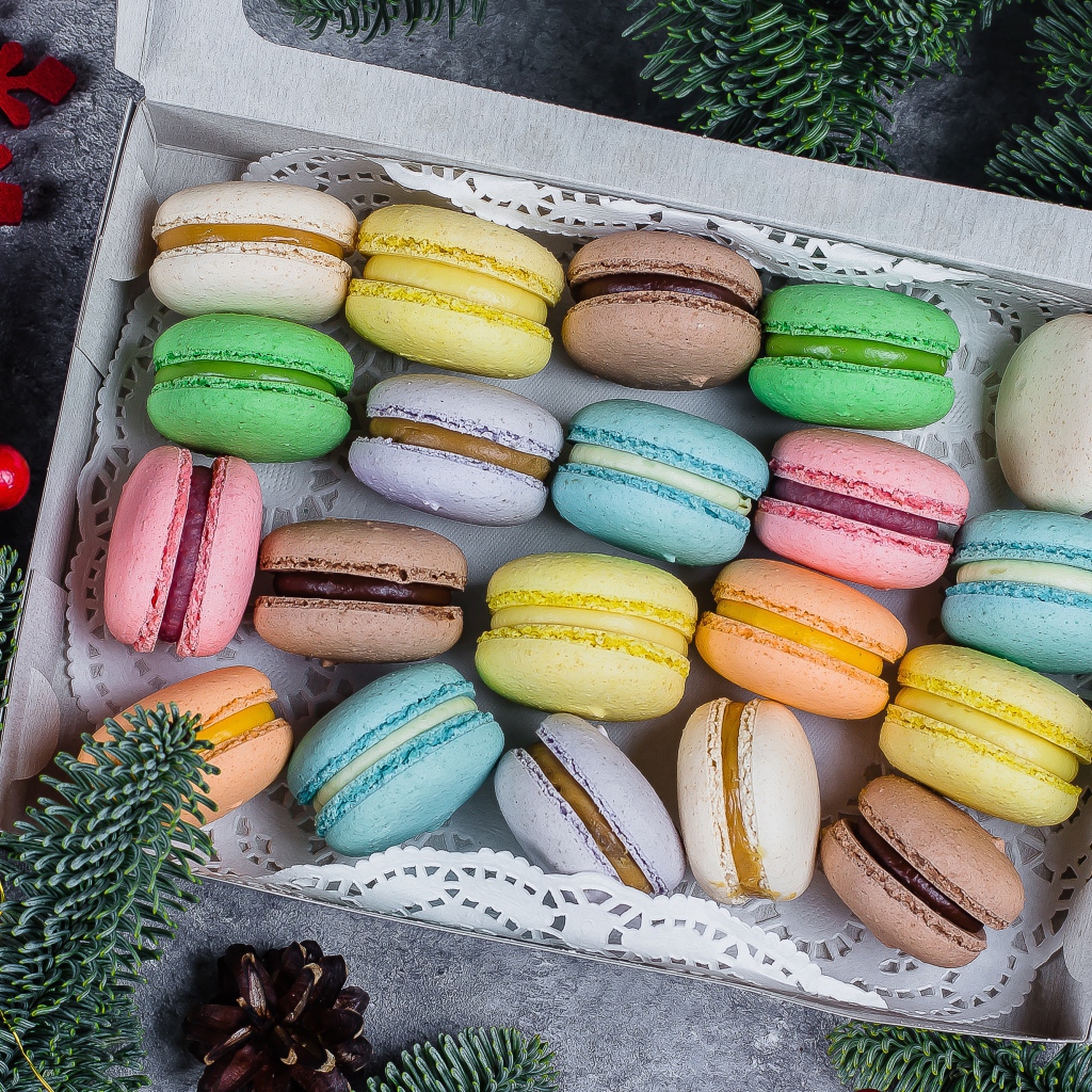Colorful macaroon cookies in a box on the table