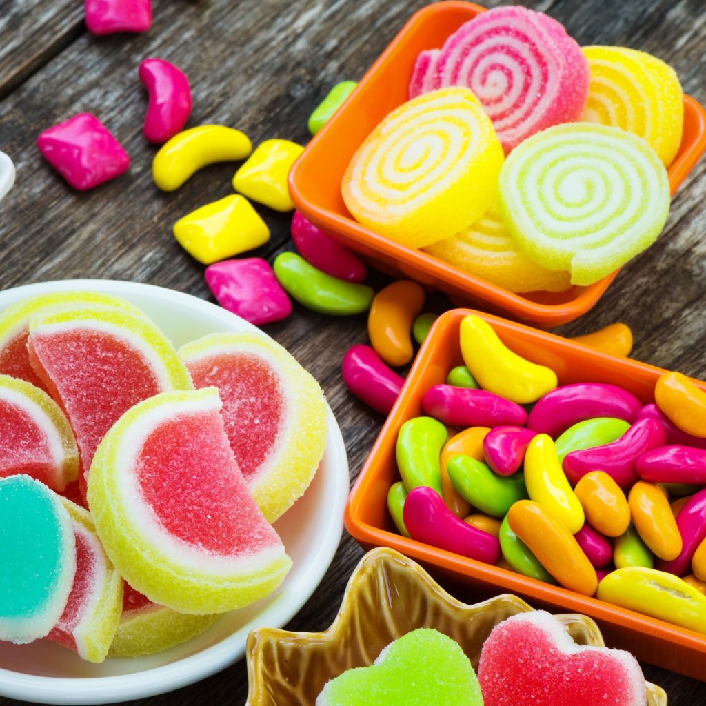 Разноцветный мармелад с конфетами на деревянном столе