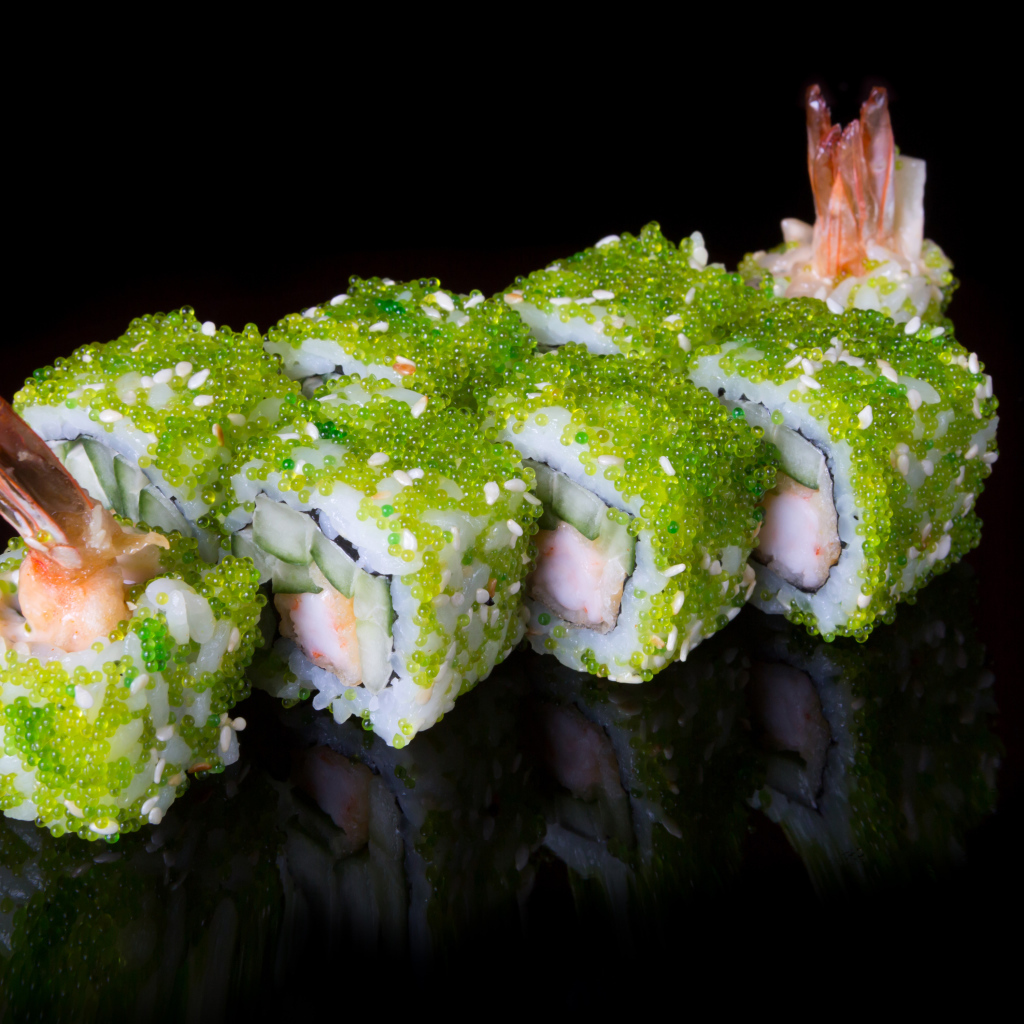 Sushi with caviar and shrimps on a black background