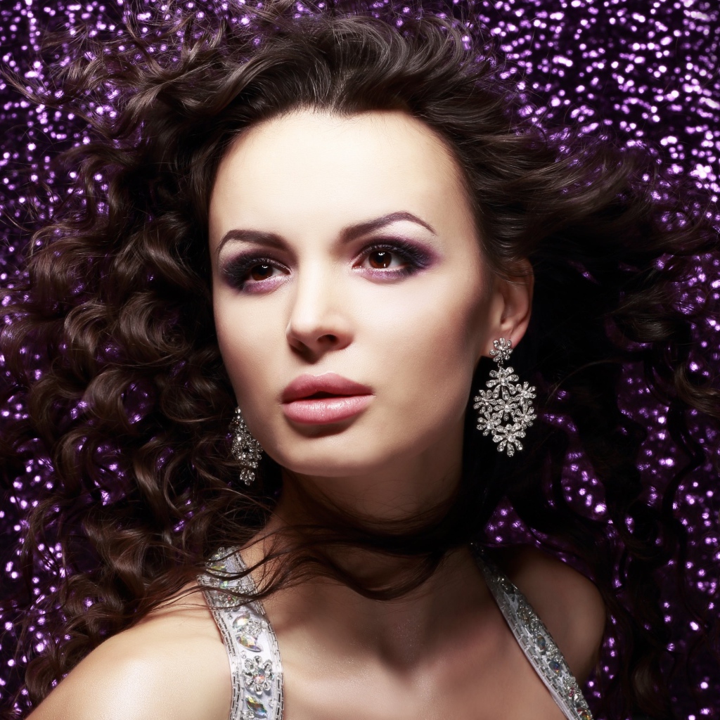 Красивая шатенка на блестящем фоне