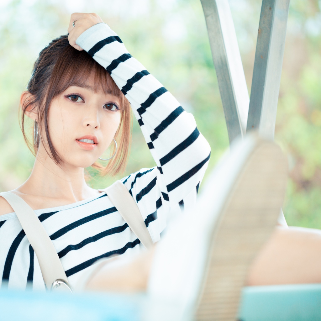 Кареглазая девушка азиатка в полосатом свитере