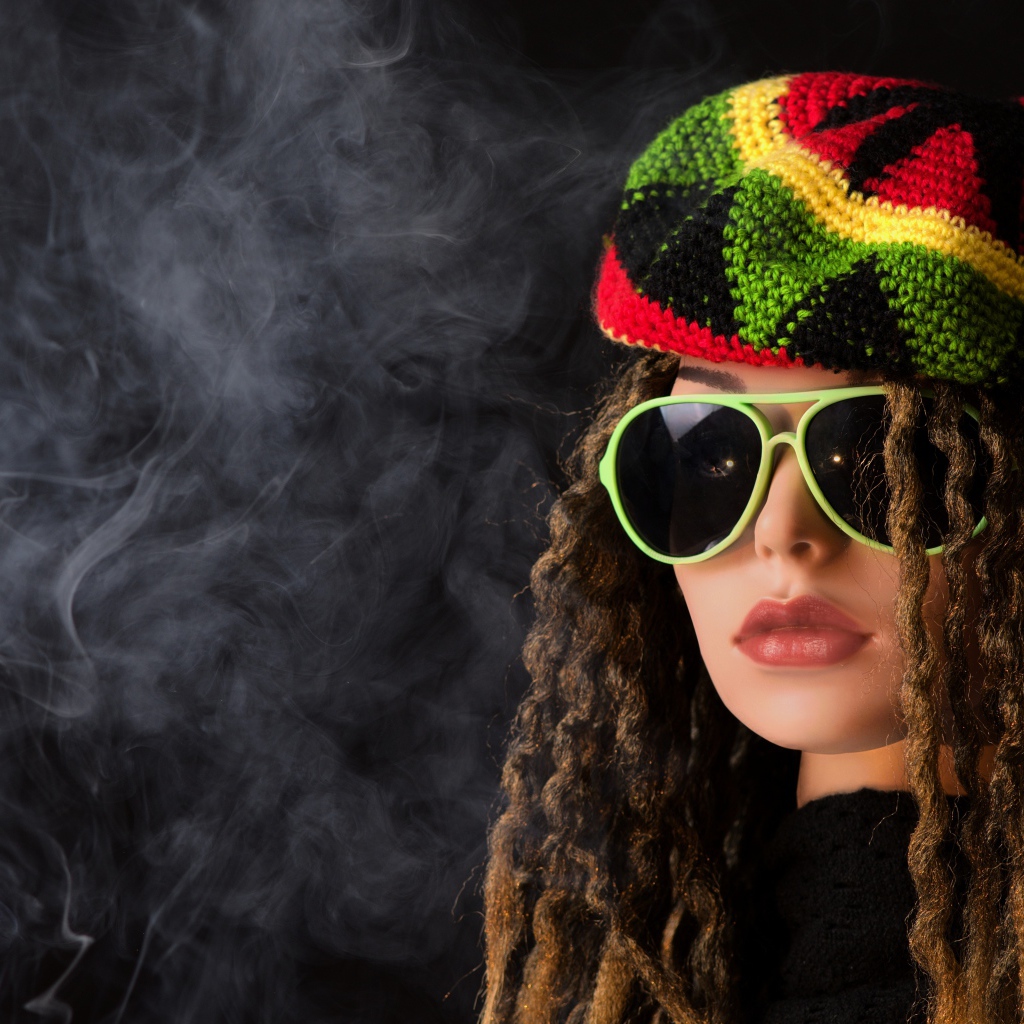 Девушка растаманка в черных очках в дыму