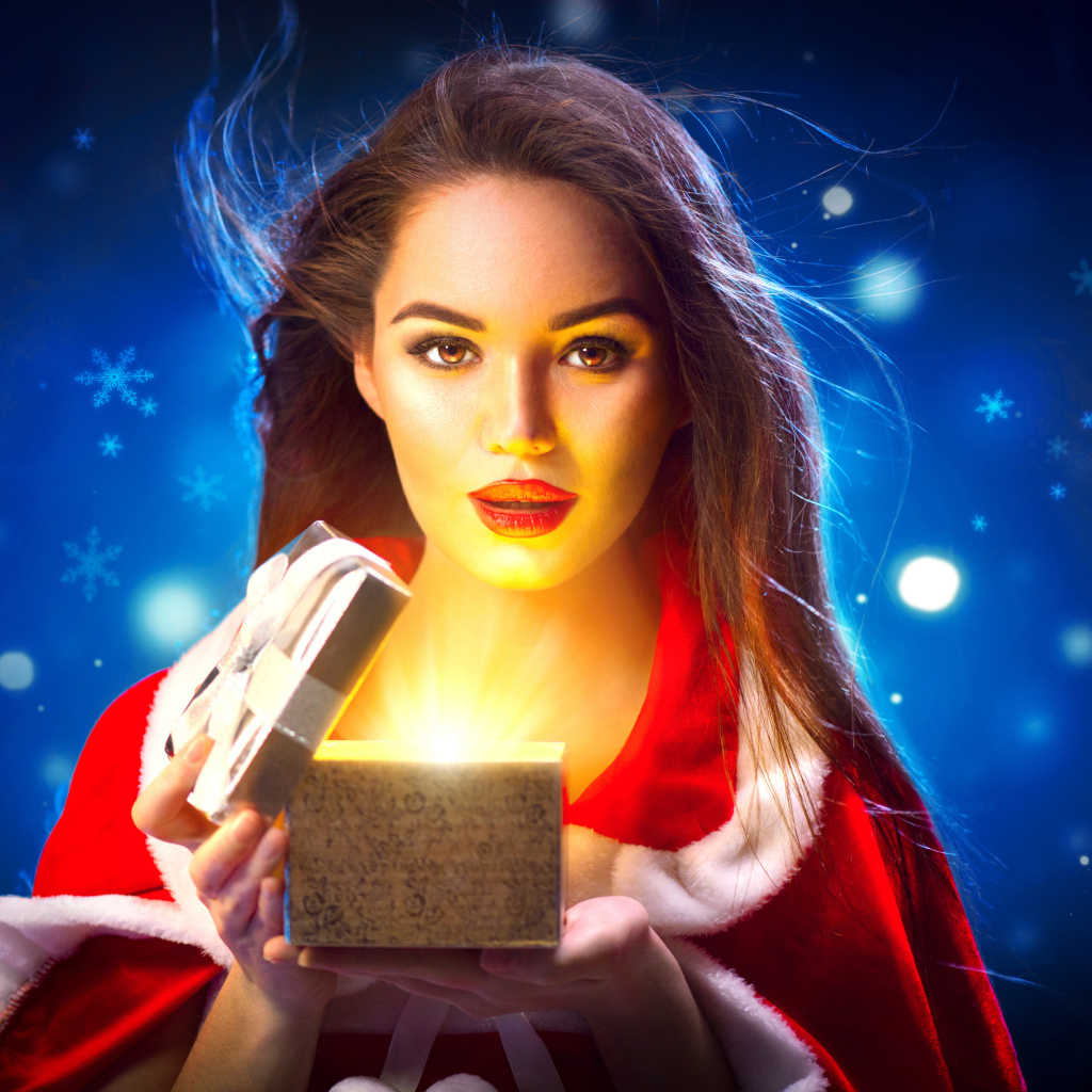 Красивая девушка открывает коробку с подарком на новый год 