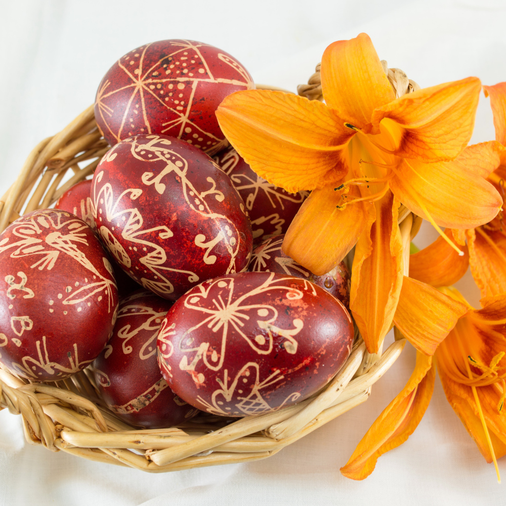 Beautiful painted Easter eggs on a white background with lily flowers