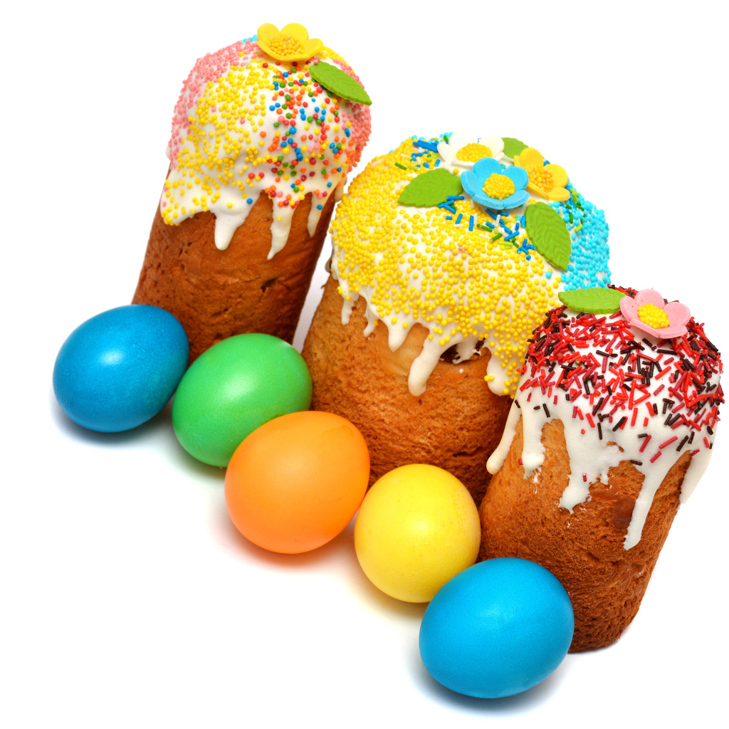 Three Easter cakes with painted eggs on a white background for the holiday Easter