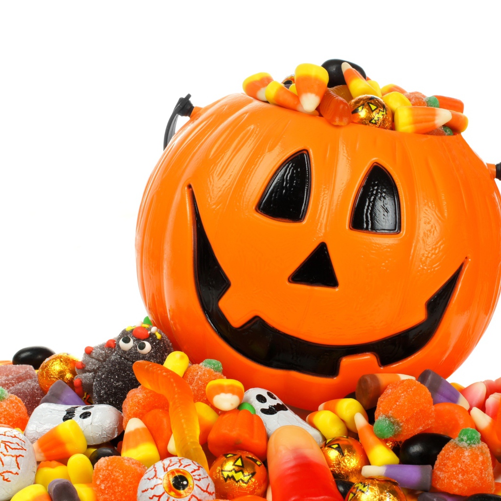 Тыква со сладостями на белом фоне