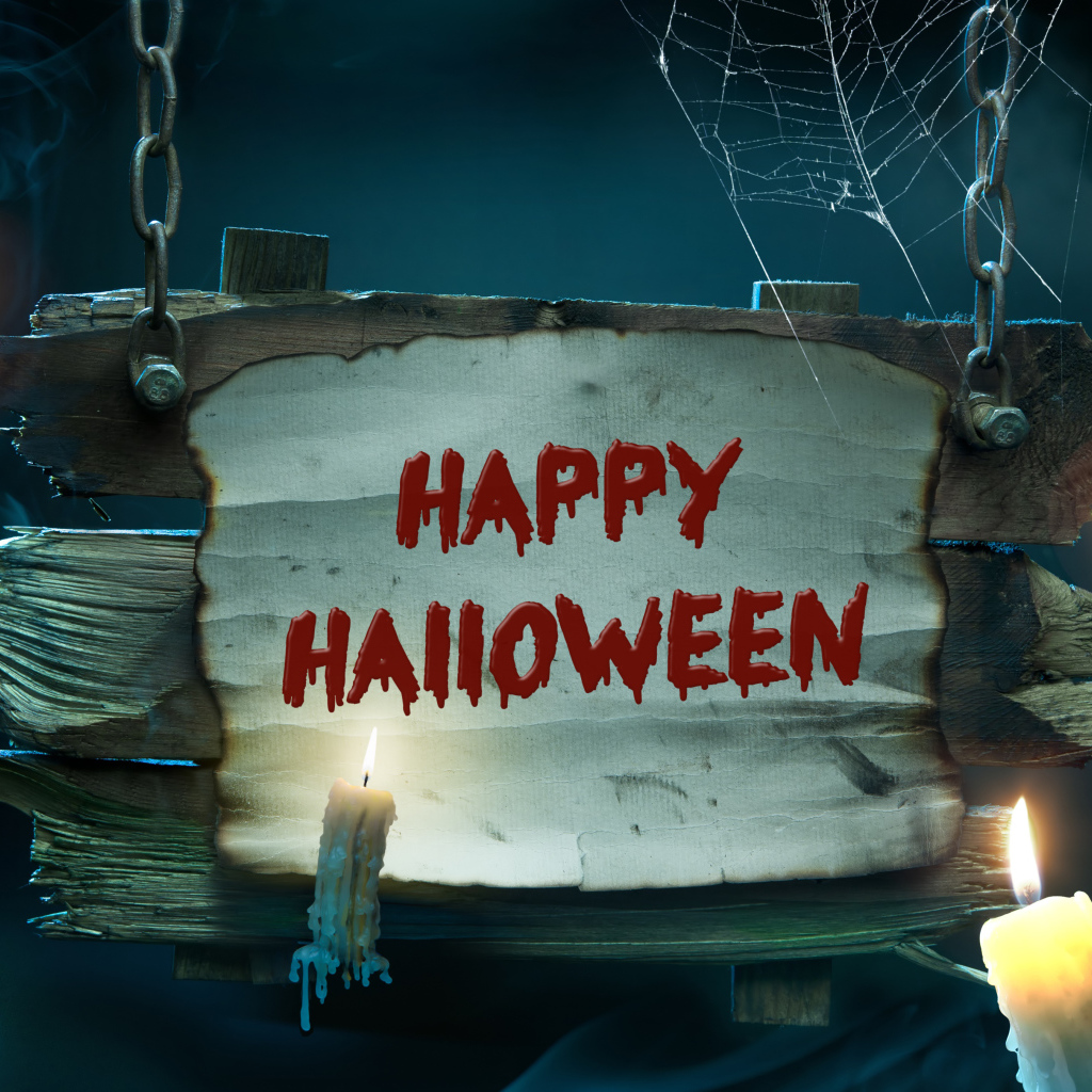 Страшная надпись Счастливого Хэллоуина на деревянной табличке со свечами