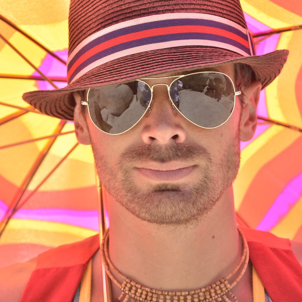 Мужчина в солнечных очках и шляпе летом
