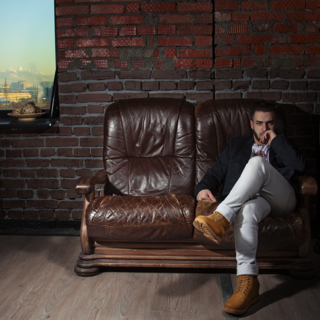 Stylish man sitting in a leather chair