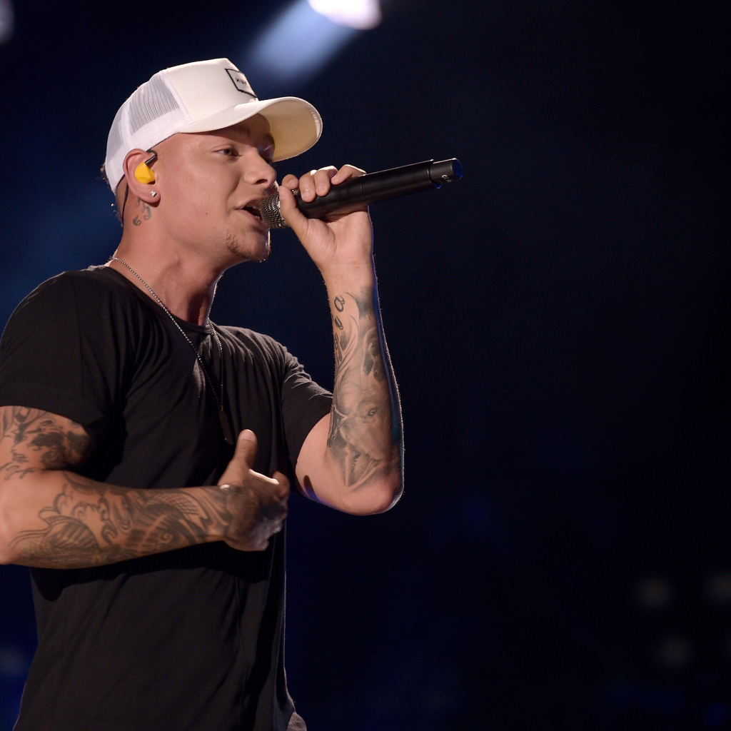 American country singer Kane Brown with a microphone on stage