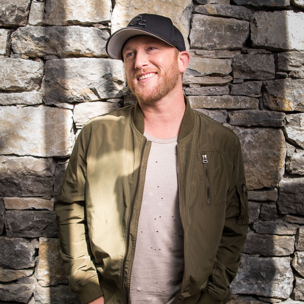 Музыкант Коул Суинделл в бейсболке у стены