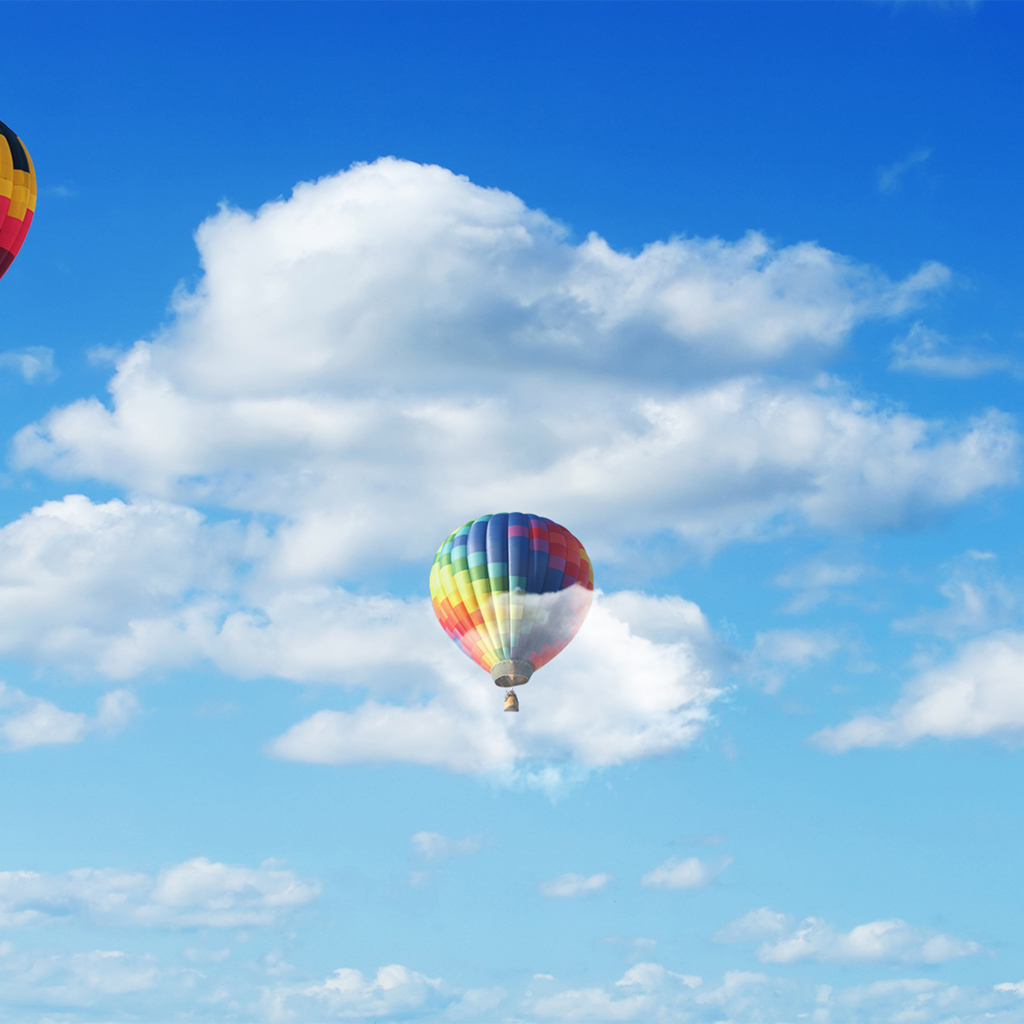 Воздушные шары в голубом небе с белыми облаками 