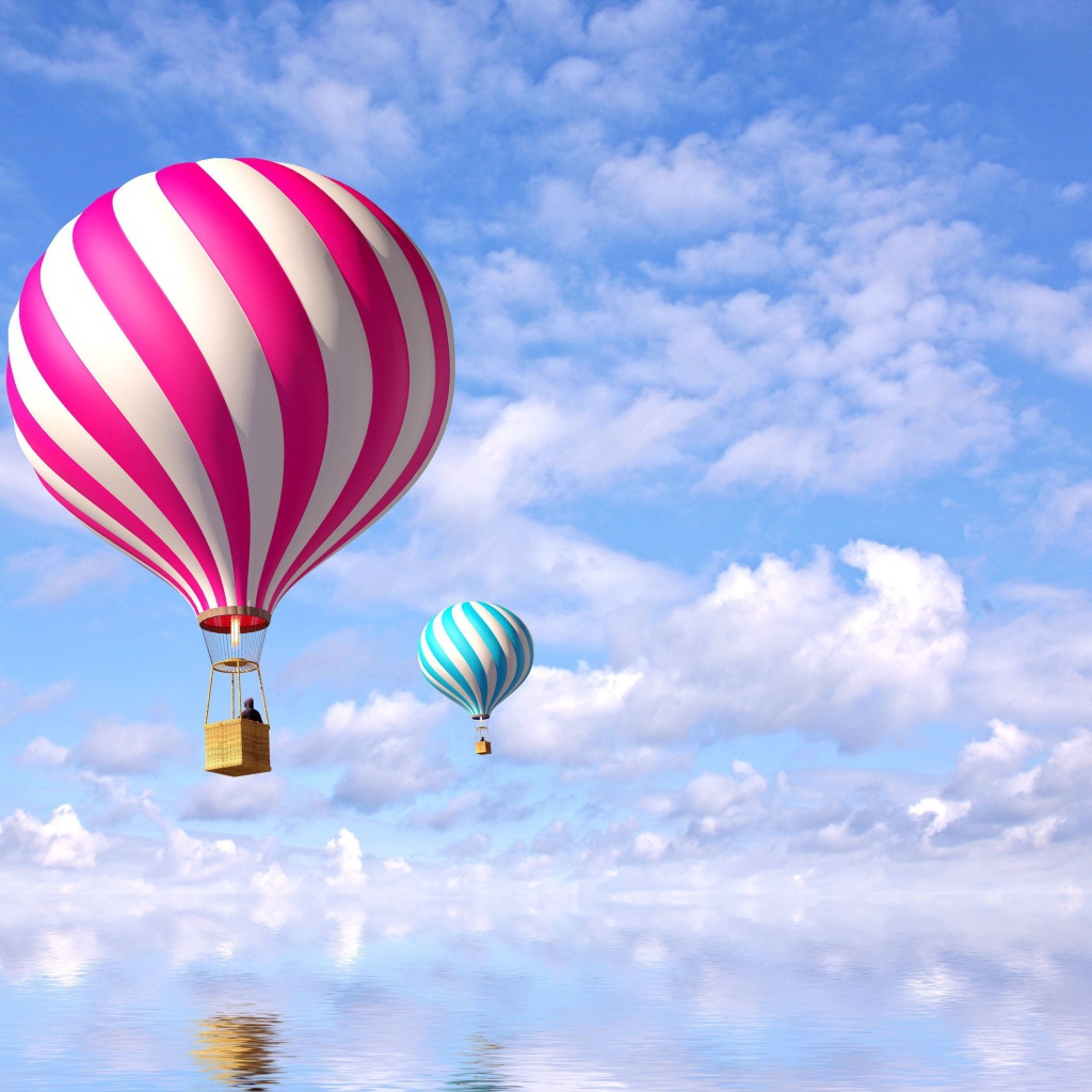 Яркие воздушные шары в небе над водой