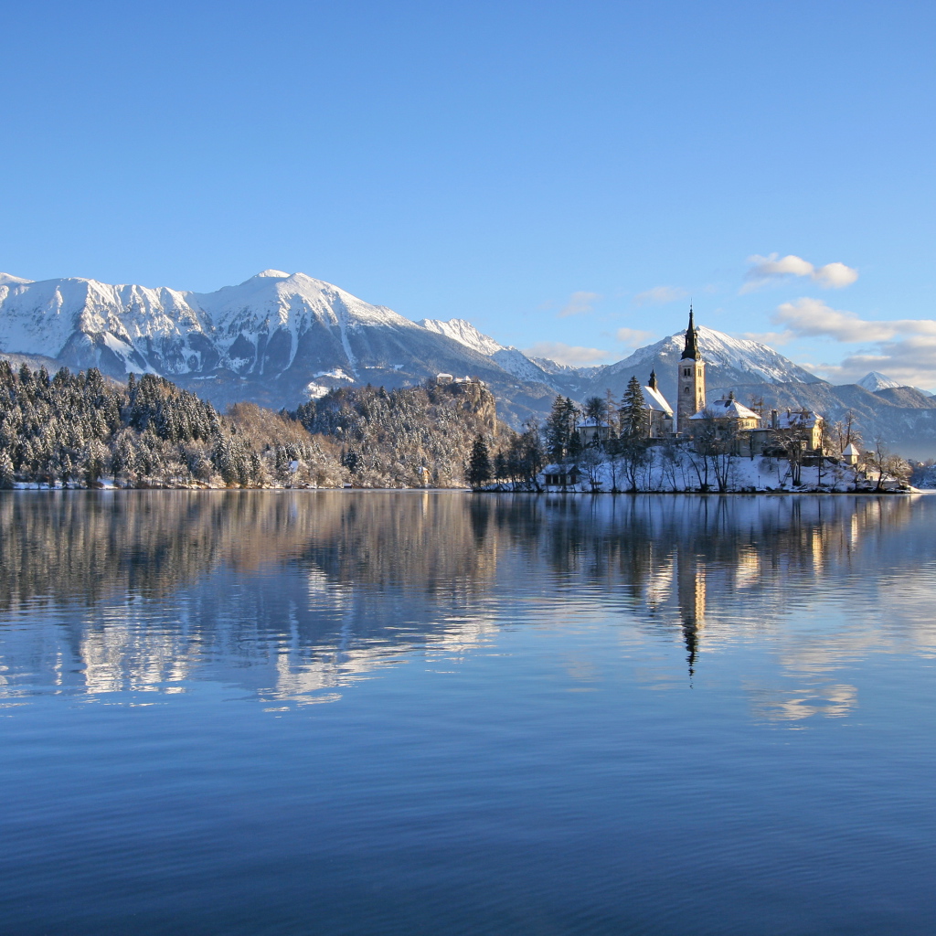 Beautiful view of the snow-capped mountains and the lake castle