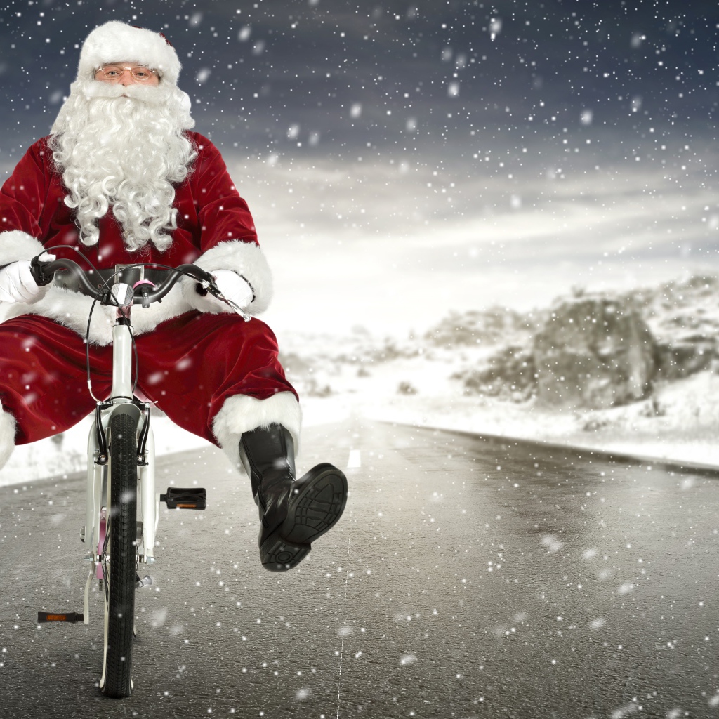 Санта Клаус на велосипеде на скользкой дороге зимой