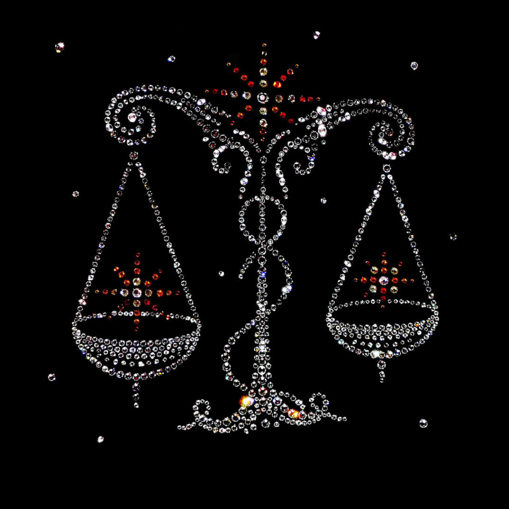 Блестящий знак зодиака весы на черном фоне