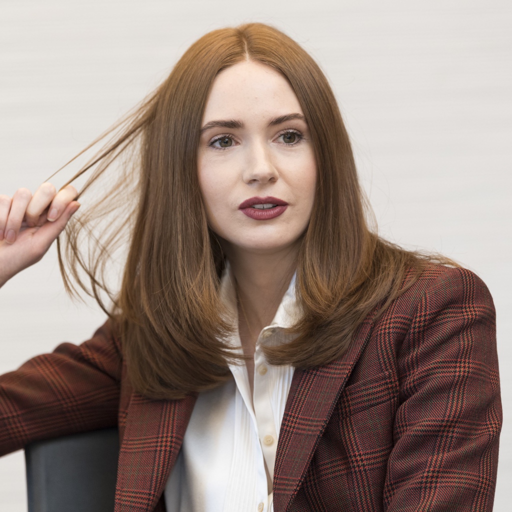 Актриса Карен Гиллан в пиджаке держит волосы