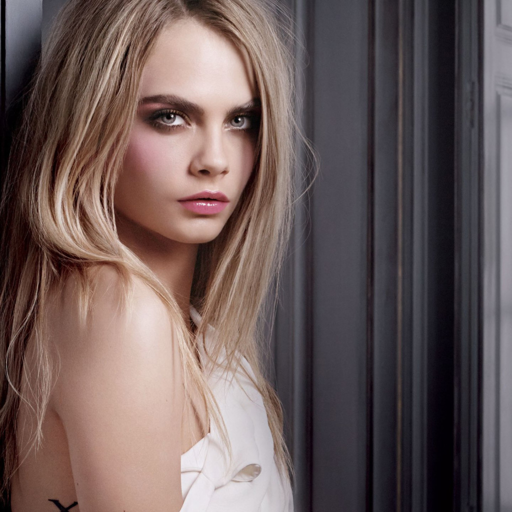 Красивая девушка, актриса Кара Делевинь у стены