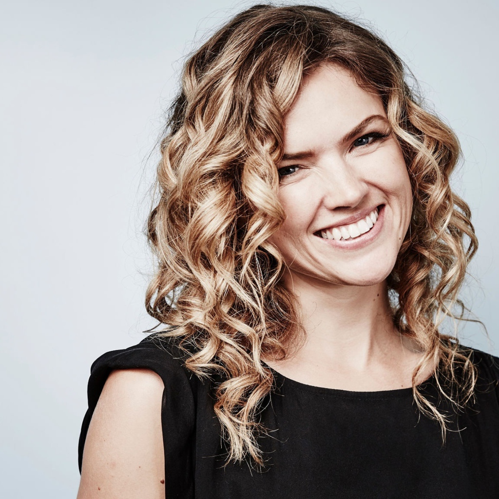 Улыбающаяся блондинка, актриса Эрин Ричардс на сером фоне