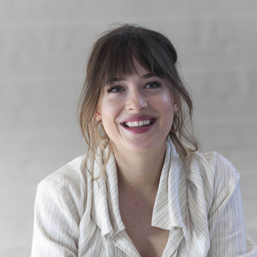 Улыбающаяся девушка актриса Дакота Джонсон в рубашке