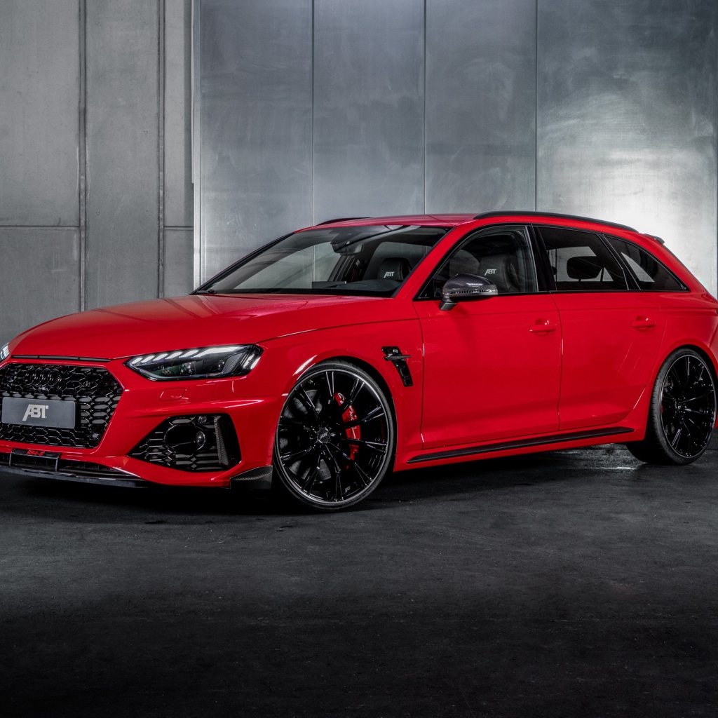 Red 2020 ABT Audi RS4 S car against a gray wall
