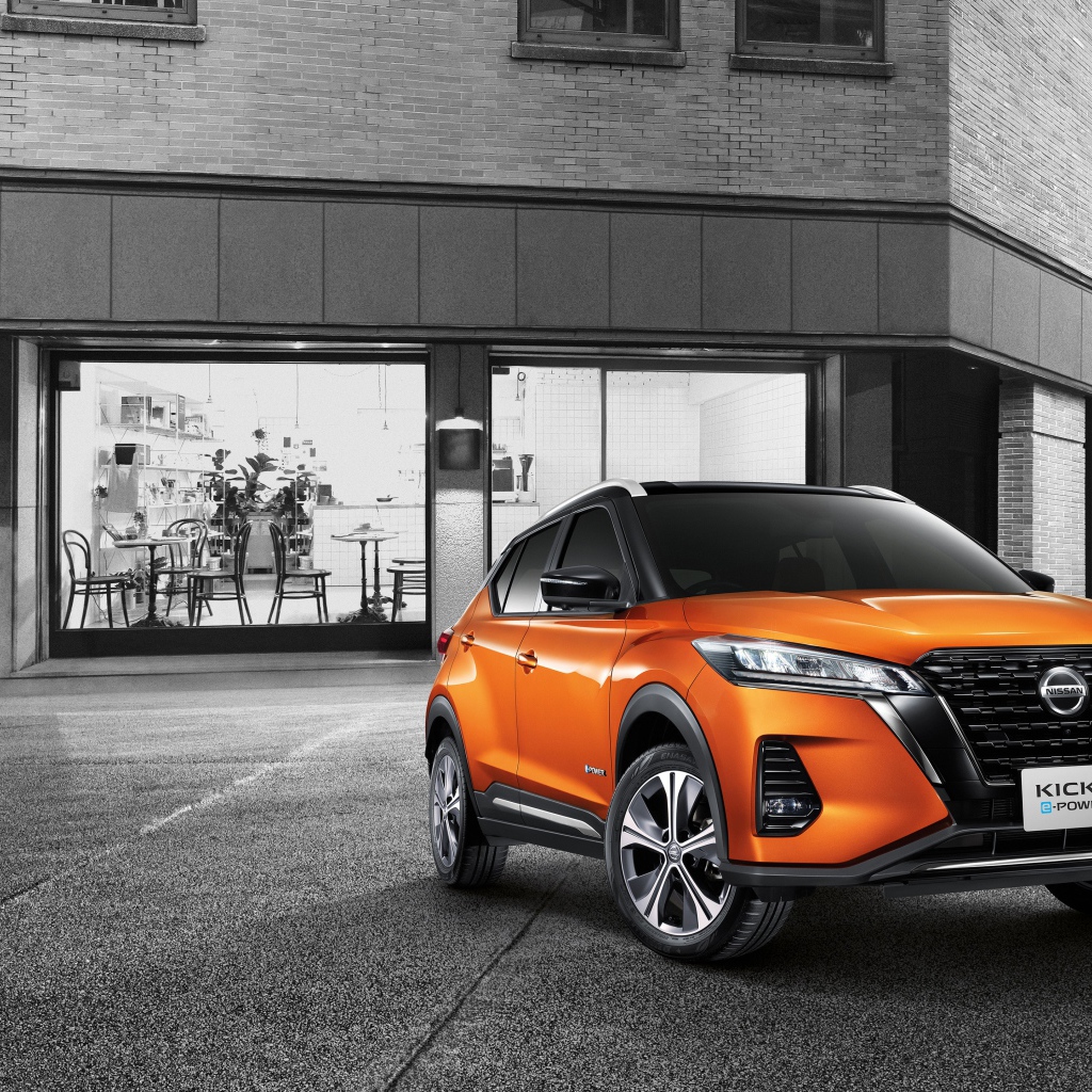 Оранжевый внедорожник Nissan Kicks E-POWER 2020 года у кафе