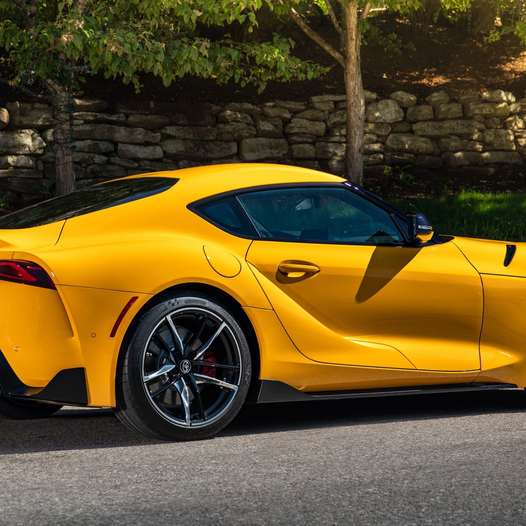 Желтый автомобиль Toyota GR Supra 2, 2021 года вид сбоку 
