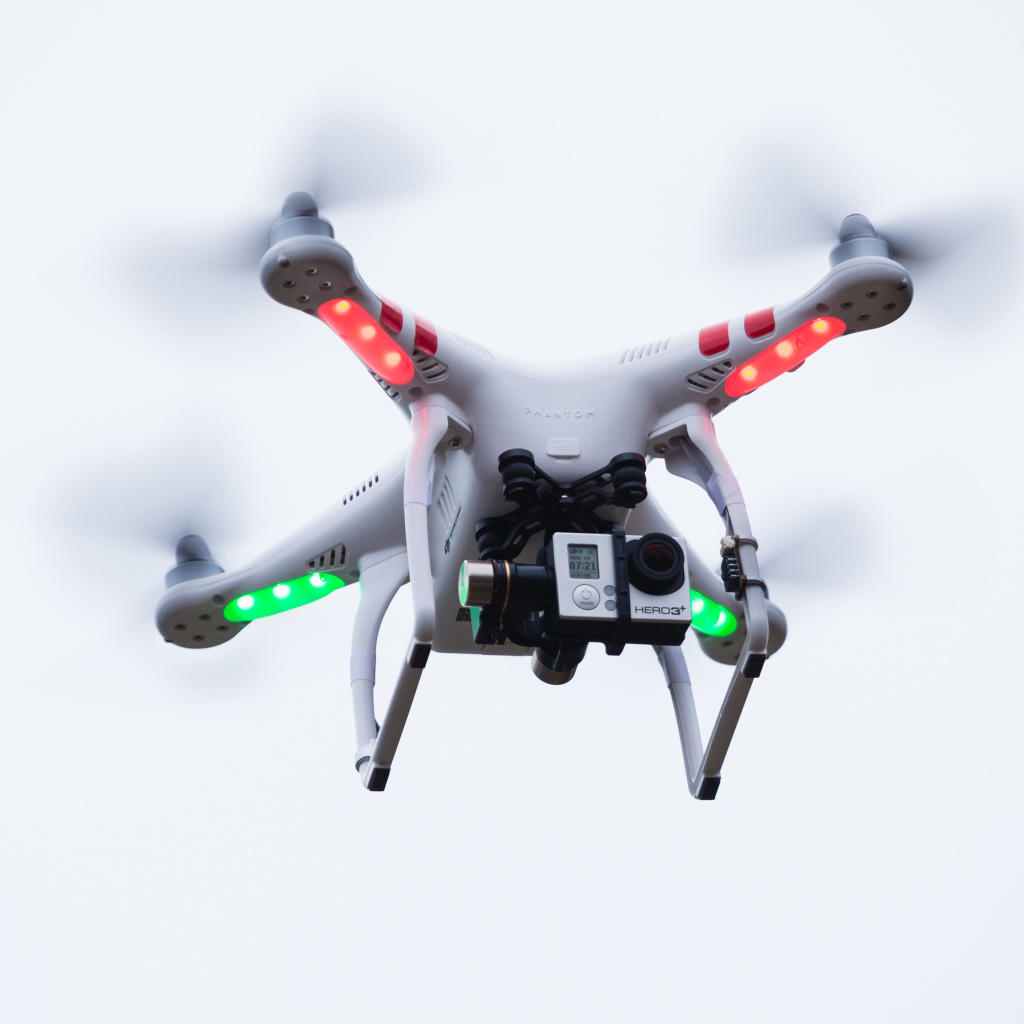 Quadrocopter with a video camera on a white background